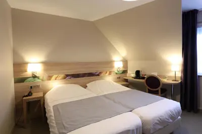 Un ou plusieurs lits dans un hébergement de l'établissement Hotel Restaurant Le Coquelicot