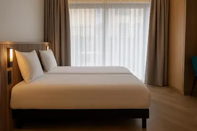 Un ou plusieurs lits dans un hébergement de l'établissement Brit Hotel Grand Hotel Munster