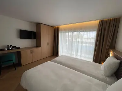 Un ou plusieurs lits dans un hébergement de l'établissement Brit Hotel Grand Hotel Munster