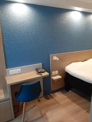 Un ou plusieurs lits dans un hébergement de l'établissement Brit Hotel Mulhouse Centre