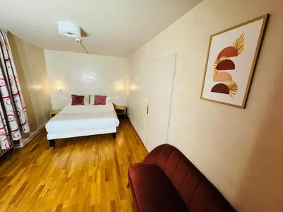 Un ou plusieurs lits dans un hébergement de l'établissement Hôtel- Restaurant Merveilles88
