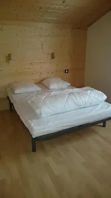 Un ou plusieurs lits dans un hébergement de l'établissement Camping du Ô des bluches