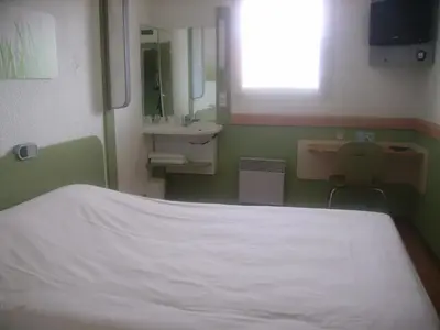 Un ou plusieurs lits dans un hébergement de l'établissement ibis budget Remiremont