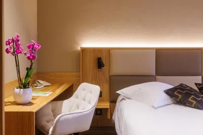 Un ou plusieurs lits dans un hébergement de l'établissement Hotel Au Nid De Cigognes