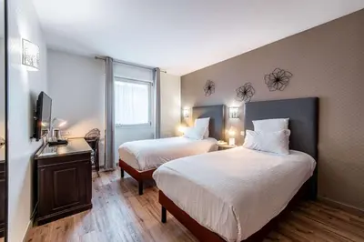 Un ou plusieurs lits dans un hébergement de l'établissement Best Western Plus Au cheval Blanc à Mulhouse