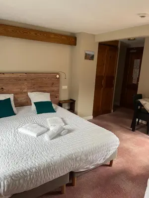 Un ou plusieurs lits dans un hébergement de l'établissement Hôtel Restaurant Valneige