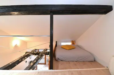 Un ou plusieurs lits dans un hébergement de l'établissement Appartement La Terrasse sur cour
