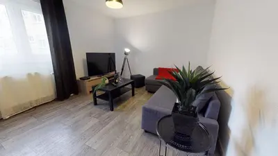Télévision ou salle de divertissement dans l'établissement Les Charpentiers