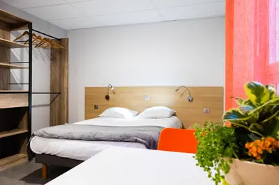 Un ou plusieurs lits dans un hébergement de l'établissement Hotel-Restaurant Espace Squash 3000