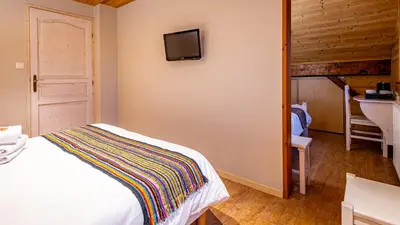 Un ou plusieurs lits dans un hébergement de l'établissement Hôtel - Restaurant Le Couchetat