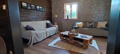 Coin salon dans l'établissement Chalet aux 2 sapins