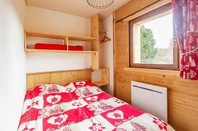 Un ou plusieurs lits dans un hébergement de l'établissement Esprit Myrtille Terrasse Vue Lac
