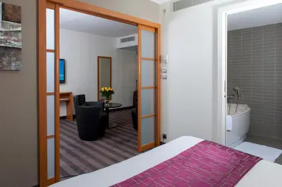Un ou plusieurs lits dans un hébergement de l'établissement Brit Hotel Belfort Centre-Le Boreal