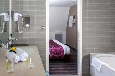 Un ou plusieurs lits dans un hébergement de l'établissement Brit Hotel Belfort Centre-Le Boreal