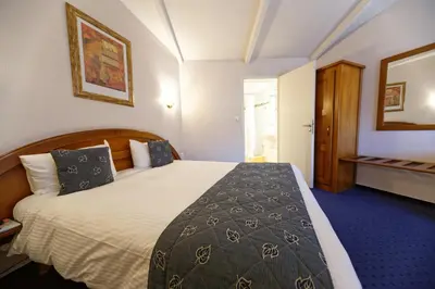 Un ou plusieurs lits dans un hébergement de l'établissement Charme Hôtel, Montbéliard Sud