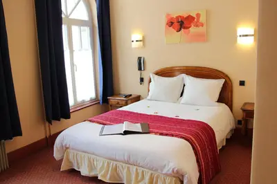 Un ou plusieurs lits dans un hébergement de l'établissement Hôtel Restaurant La Cigogne