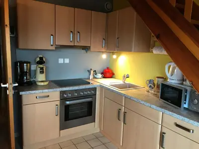 Cuisine ou kitchenette dans l'établissement Les Loges du Lac - Appartement avec Terrasse