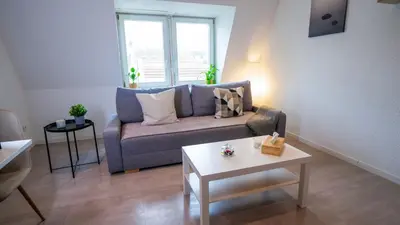 Coin salon dans l'établissement Le 4 - Très beau appartement T3 Neuf, tout confort, Mulhouse centre ville - stationnement gratuit