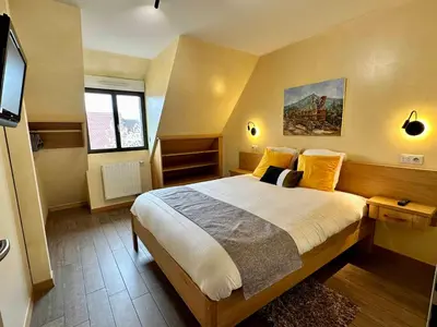 Un ou plusieurs lits dans un hébergement de l'établissement Les Chambres Du Vignoble