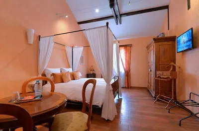 Un ou plusieurs lits dans un hébergement de l'établissement B&B Le Clos des Raisins