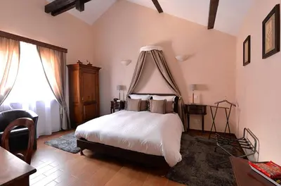 Un ou plusieurs lits dans un hébergement de l'établissement B&B Le Clos des Raisins