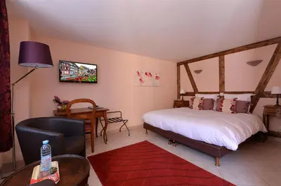 Un ou plusieurs lits dans un hébergement de l'établissement B&B Le Clos des Raisins