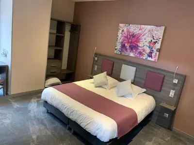 Un ou plusieurs lits dans un hébergement de l'établissement Hotel-Restaurant St-Christophe