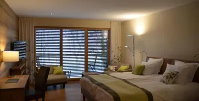 Un ou plusieurs lits dans un hébergement de l'établissement Hotel Le Caballin