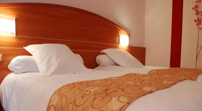 Un ou plusieurs lits dans un hébergement de l'établissement Hotel Cigoland