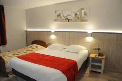 Un ou plusieurs lits dans un hébergement de l'établissement Hotel Restaurant Au Parc des Cigognes