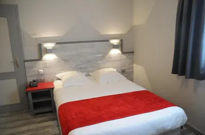 Un ou plusieurs lits dans un hébergement de l'établissement Hotel Restaurant Au Parc des Cigognes