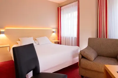 Un ou plusieurs lits dans un hébergement de l'établissement Hôtel Restaurant Logis Auberge Sundgovienne