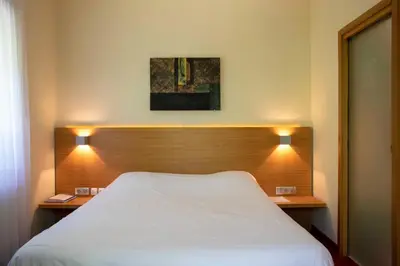 Un ou plusieurs lits dans un hébergement de l'établissement Hôtel Restaurant Logis Auberge Sundgovienne