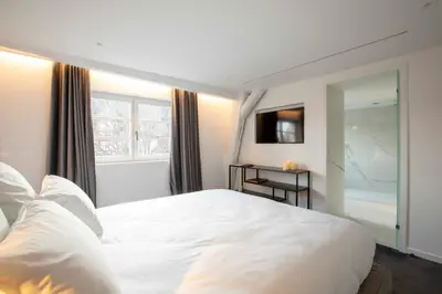 Un ou plusieurs lits dans un hébergement de l'établissement BORD EAU Guest House