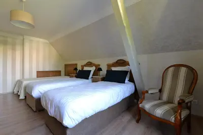 Un ou plusieurs lits dans un hébergement de l'établissement Gîte Aux Deux Clochers