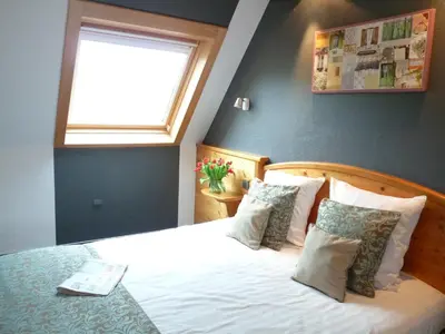 Un ou plusieurs lits dans un hébergement de l'établissement Hôtel Le Riquewihr
