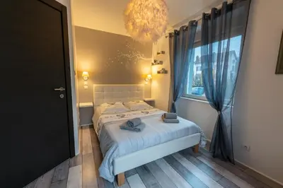 Un ou plusieurs lits dans un hébergement de l'établissement Gîte l'Améthyste 3 appartements