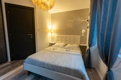 Un ou plusieurs lits dans un hébergement de l'établissement Gîte l'Améthyste 3 appartements