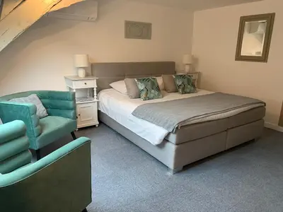 Un ou plusieurs lits dans un hébergement de l'établissement Hotel SPA Au Cheval Blanc