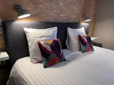 Un ou plusieurs lits dans un hébergement de l'établissement Hotel SPA Au Cheval Blanc