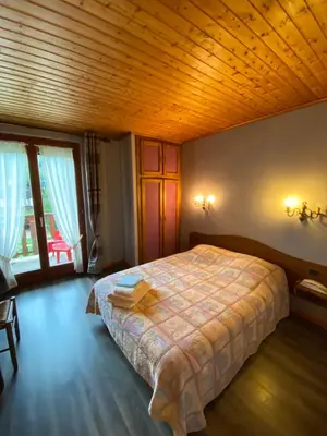 Un ou plusieurs lits dans un hébergement de l'établissement Le Chalet