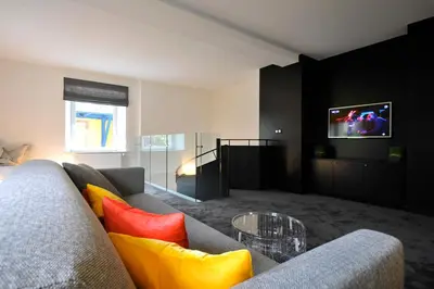 Télévision ou salle de divertissement dans l'établissement Le Duplex de Jules
