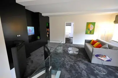 Télévision ou salle de divertissement dans l'établissement Le Duplex de Jules