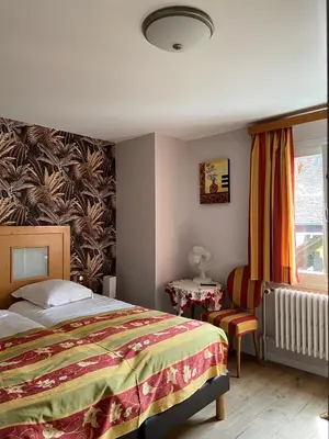 Un ou plusieurs lits dans un hébergement de l'établissement Hotel Au Cerf