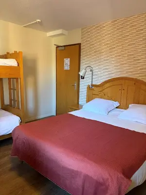 Un ou plusieurs lits dans un hébergement de l'établissement Hotel Au Cerf
