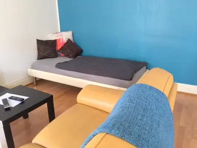 Coin salon dans l'établissement L'Appart Bleu - Lumineux F3 Mulhouse Gare/Centre