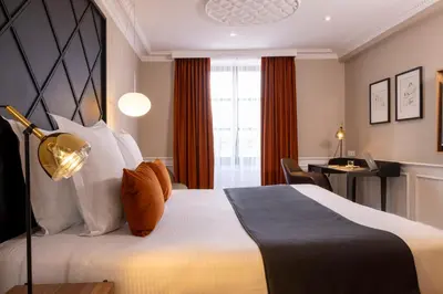 Un ou plusieurs lits dans un hébergement de l'établissement Hotel Le Colombier