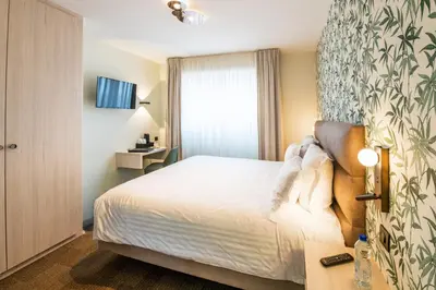 Un ou plusieurs lits dans un hébergement de l'établissement Hotel Restaurant Au Riesling