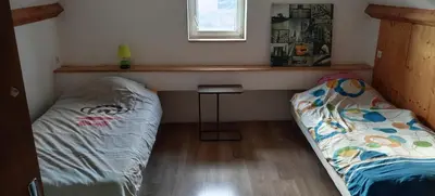 Un ou plusieurs lits dans un hébergement de l'établissement maison bleue