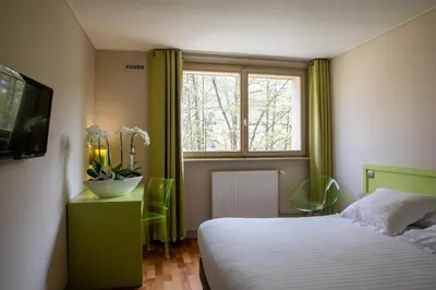Un ou plusieurs lits dans un hébergement de l'établissement Hotel Du Lac